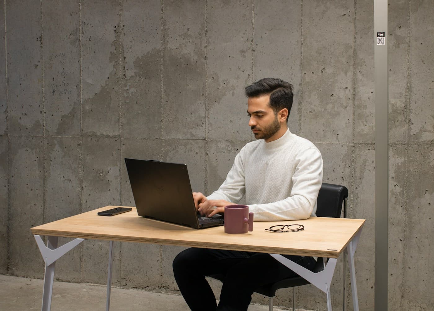 A developer working through a build at a plain desk