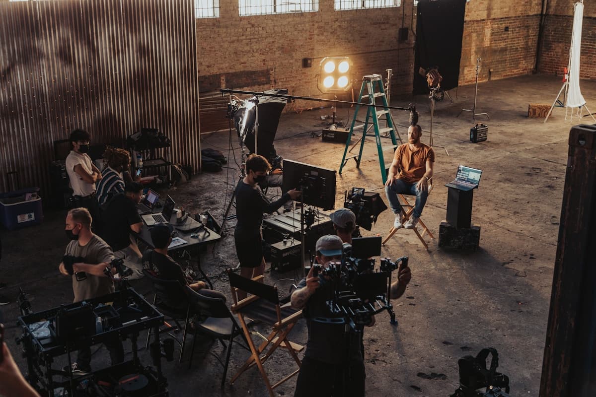 A film crew setting up an interview in a warehouse studio