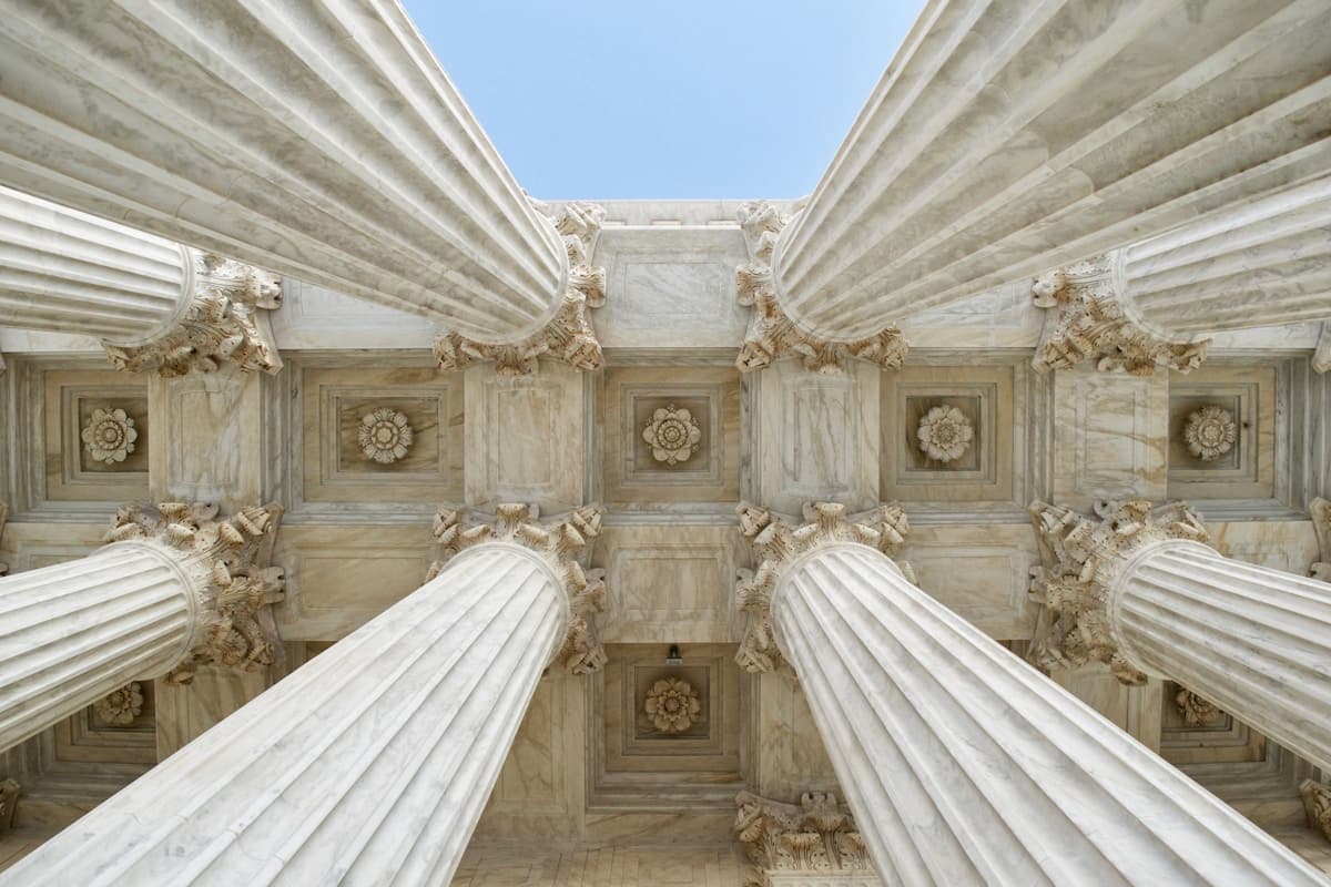 Stone columns of a civic building seen from below
