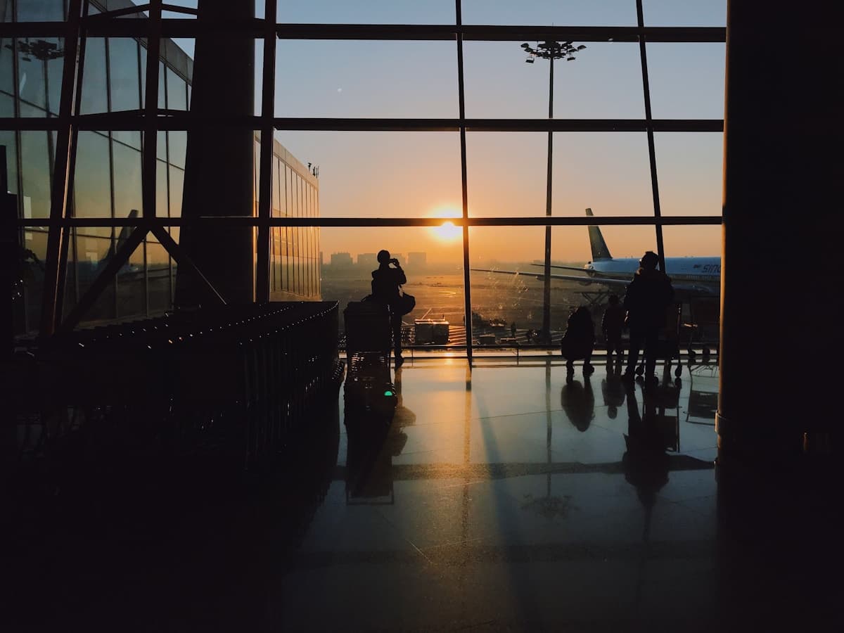 Travellers in an airport terminal at sunrise
